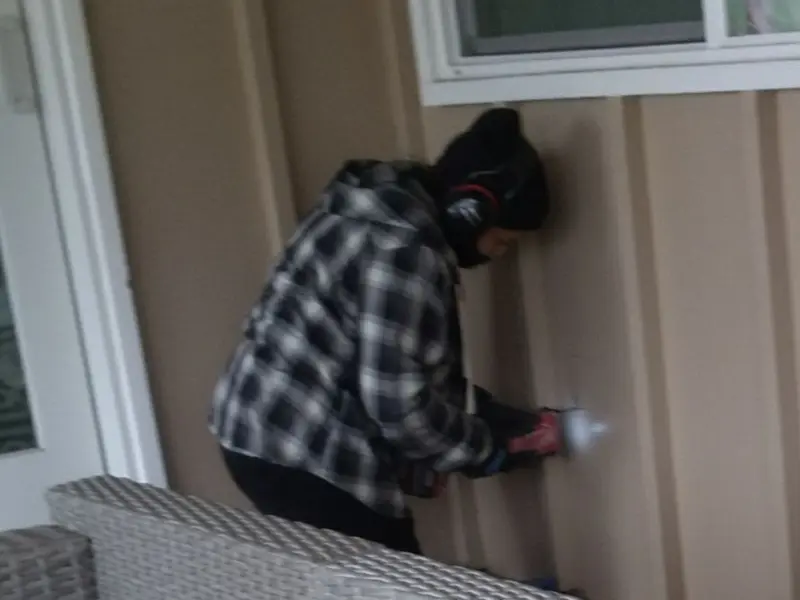 Professional electrician installing an exterior outlet in Cortland