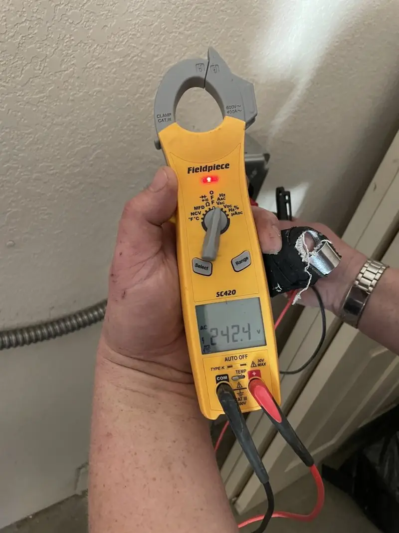Voltage testing with clamp meter during Electrical Installation Services in Cortland